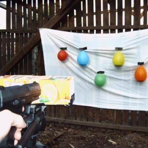 Shooting C.O., 2006, shooting from back through camera obscura, the projectile first creates a hole through the film then a pinhole and destructs the baloon, documentation view